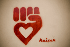 A fist with the palm in the shape of a heart.